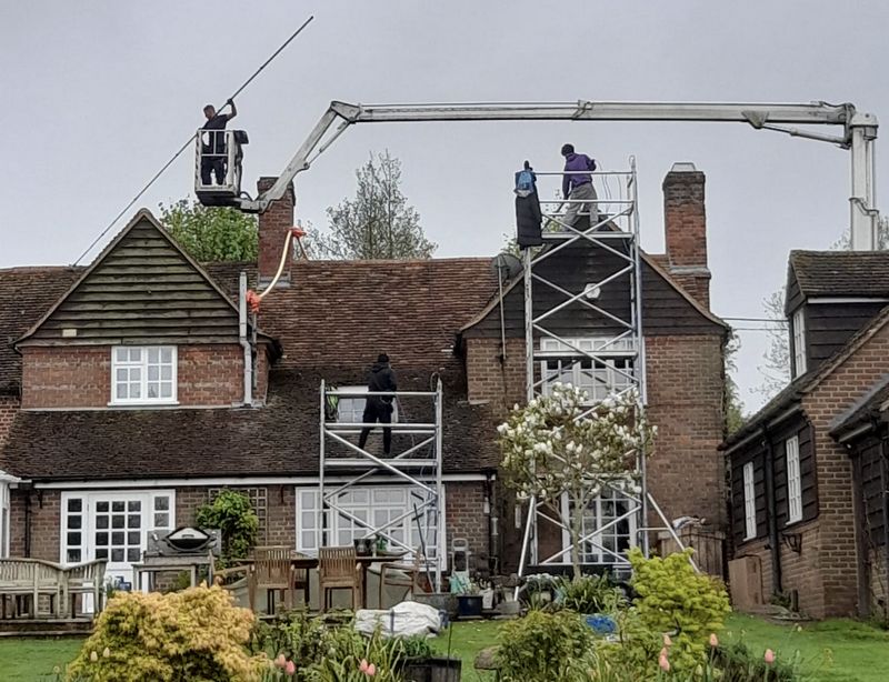 The Roof Moss Cleaners using cherry picker and scaffolding to clean roof safely and professionally in Sunninghill, Berkshire