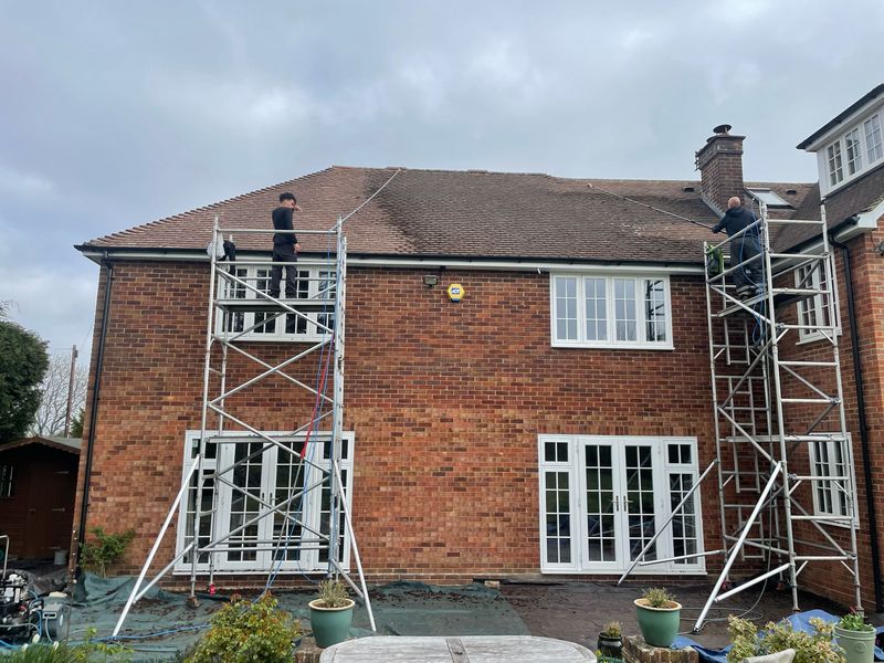 Roof cleaning carried out safely from scaffold towers by The Roof Moss Cleaners in Sunninghill